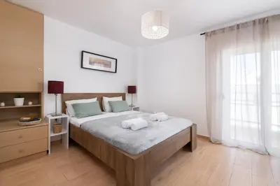 a bedroom with a large bed with two towels on it at Elli City Apartment in Rhodes Town
