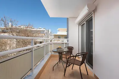 a balcony with a table and chairs on it at Elli City Apartment in Rhodes Town