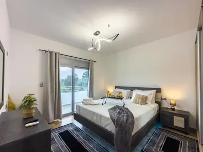 a bedroom with a large bed and a window at La casa di pantelis with Luxury Pool in Archangelos