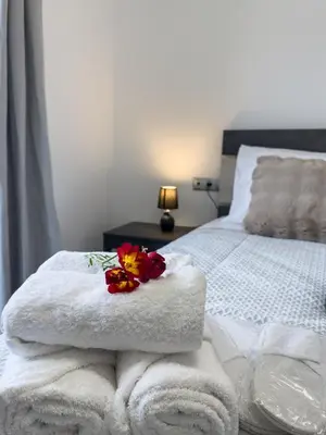 a bed with towels and flowers on top of it at La casa di pantelis with Luxury Pool in Archangelos