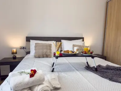 a bed with a tray of food on it at La casa di pantelis with Luxury Pool in Archangelos
