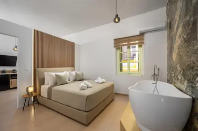 a bedroom with a bed and a bath tub at Agkyra Studio in Symi