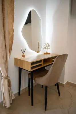 a desk with a chair and a mirror at The Azure Suites in Haraki