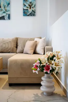 a living room with a couch and a vase with flowers at The Azure Suites in Haraki