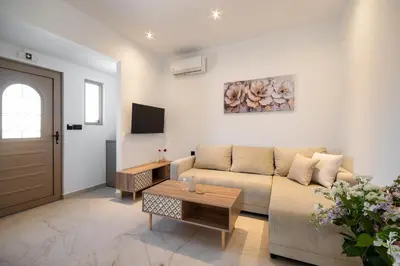 a living room with a couch and a table at The Azure Suites in Haraki