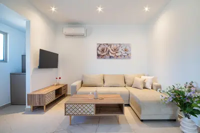 a living room with a couch and a table at The Azure Suites in Haraki
