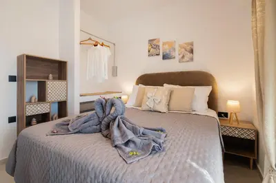 a bedroom with a bed with towels on it at The Azure Suites in Haraki