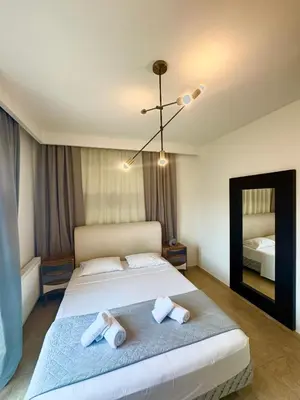 a bedroom with a large bed with towels on it at Rhodes Villa 365 in Rhodes Town