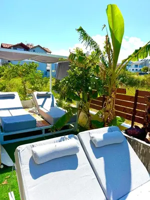 two lounge chairs and towels on a table in a yard at Rhodes Villa 365 in Rhodes Town