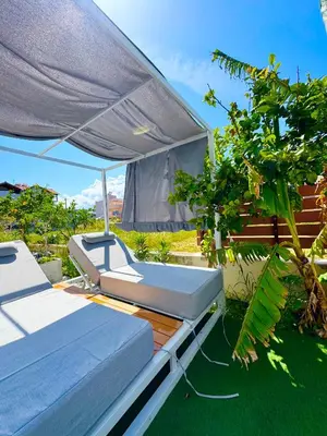 two beds on a deck with an umbrella at Rhodes Villa 365 in Rhodes Town