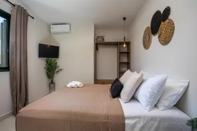 a bedroom with a large bed with white pillows at Lythari Summer Villa in Afantou