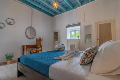 a bedroom with a bed with a stuffed animal on it at Xenofon Traditional Rooms in Rhodes Town