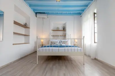 a bedroom with a bed with a blue ceiling at Xenofon Traditional Rooms in Rhodes Town