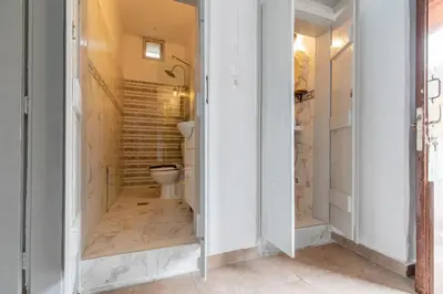 a bathroom with a toilet in a room at Xenofon Traditional Rooms in Rhodes Town