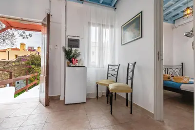 a small kitchen with two chairs and a table at Xenofon Traditional Rooms in Rhodes Town