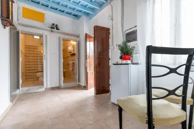 a room with a chair and a bathroom at Xenofon Traditional Rooms in Rhodes Town