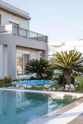 a house with a swimming pool in front of a house at Villa Afandou Bliss with private pool & panoramic sea view in Afantou