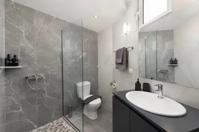 a bathroom with a toilet and a sink and a shower at Golden sand 4 in Ialyssos