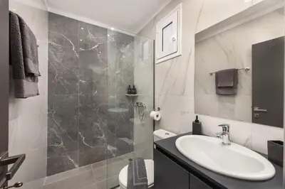 a bathroom with a sink and a shower at Golden sand 5 in Ialyssos