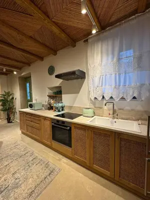 a kitchen with a sink and a stove at Aetheria Traditional House 2 in Koskinou