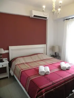a bedroom with a bed with two towels on it at Eleni Boutique Apartment in Líndos
