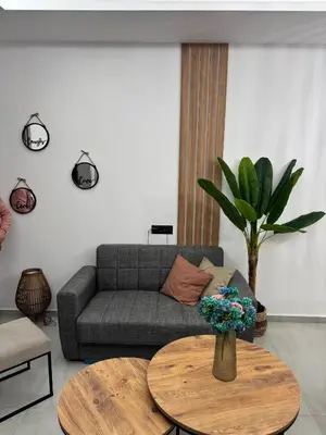 a living room with a couch and a table at Meraki Apartment in Kremasti