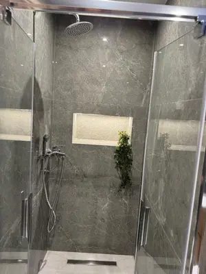 a bathroom with a shower with a glass door at Meraki Apartment in Kremasti