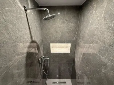 a bathroom with a shower with a shower head at Meraki Apartment in Kremasti