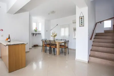 a kitchen and dining room with a table and chairs at Ennisfree Villa in Kiotari