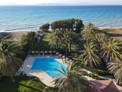 an aerial view of a resort with a swimming pool and the ocean at Paras Beach Apartments in Ialyssos