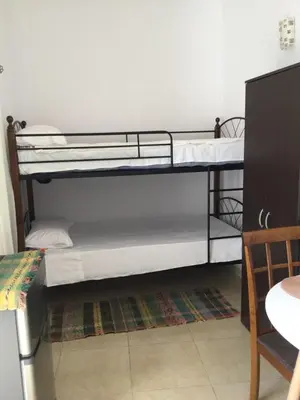 two bunk beds in a room with a table at Laertis Studio in Kattavía