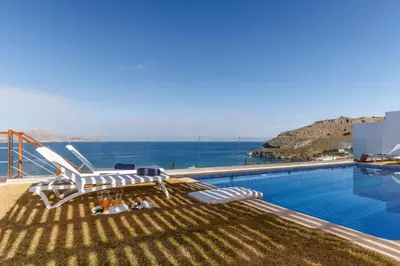 a swimming pool with a view of the ocean at Lindia Athena Luxury Villas in Líndos