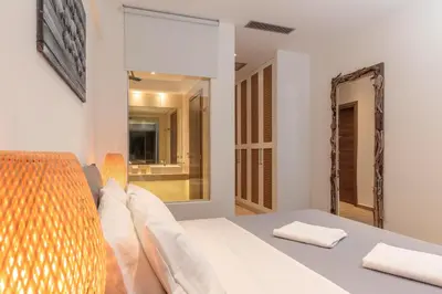 a bedroom with a bed and a large mirror at Lindia Athena Luxury Villas in Líndos