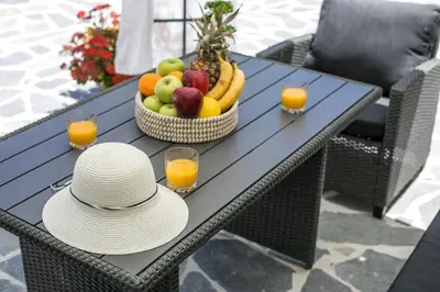 a table with a bowl of fruit and two glasses of orange juice at Oasis Luxury Villa in Rhodes Town