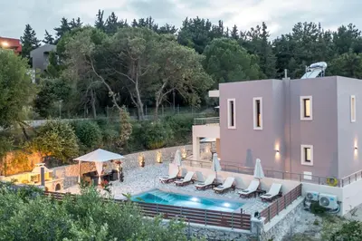 a house with a swimming pool next to a building at Oasis Luxury Villa in Rhodes Town