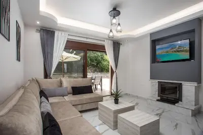 a living room with a couch and a fireplace at Oasis Luxury Villa in Rhodes Town