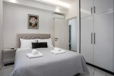 a bedroom with a bed with two towels on it at Oasis Luxury Villa in Rhodes Town