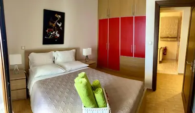 a bedroom with a bed with green towels on it at Lindos Anatoli Luxury Villa in Líndos