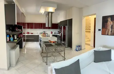 a kitchen with a couch and a table in a room at Lindos Anatoli Luxury Villa in Líndos