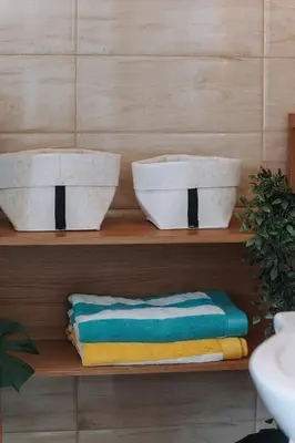 two white bowls on a shelf with towels at Leoni's House near the Beach in Kremasti