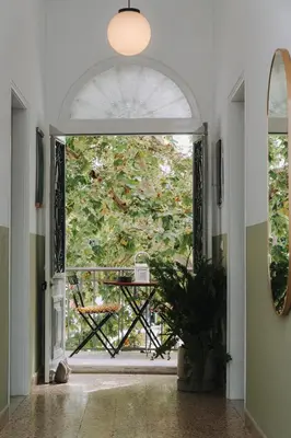 an open door to a patio with a table outside at Leoni's House near the Beach in Kremasti