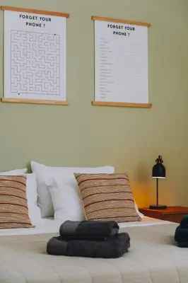 two pillows on a bed with two posters on the wall at Leoni's House near the Beach in Kremasti