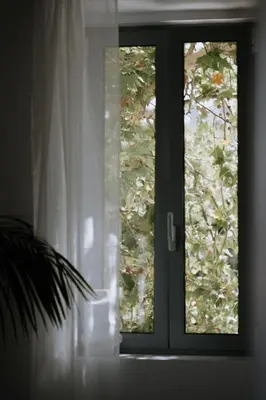 a glass door with a window in a room at Leoni's House near the Beach in Kremasti