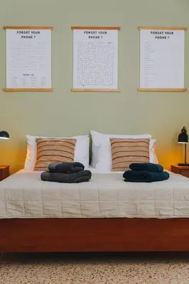 a bed with some pillows on top of it at Leoni's House near the Beach in Kremasti