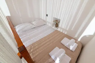 a bedroom with a bed with two towels on it at Casa della Nonna Rhodes in Gennadi