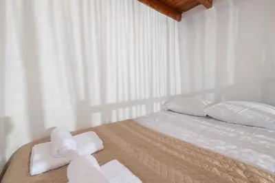a bedroom with a bed with towels on it at Casa della Nonna Rhodes in Gennadi