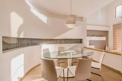 a dining room with a glass table and chairs at Filerimos Oasis Villa in Ialyssos