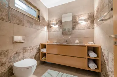 a bathroom with a toilet and a sink at Filerimos Oasis Villa in Ialyssos
