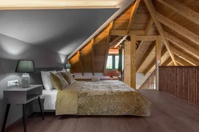 a bedroom with a bed and a wooden ceiling at ElaionHill-villa in Gennadi