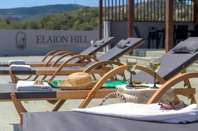 a group of picnic tables with glasses of wine at ElaionHill-villa in Gennadi